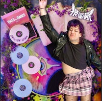 a woman in a plaid skirt is posing for a photo